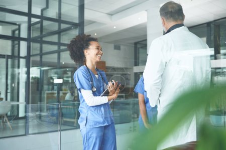 Photo for Keeping my nurses spirits high. an attractive young nurse standing with coworkers and having a discussion in the clinic - Royalty Free Image