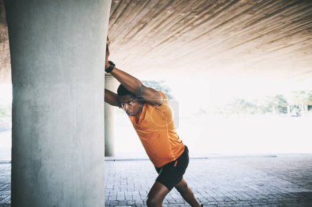 Photo for Miracles dont make muscle, discipline does. a young man stretching during a workout against an urban background - Royalty Free Image