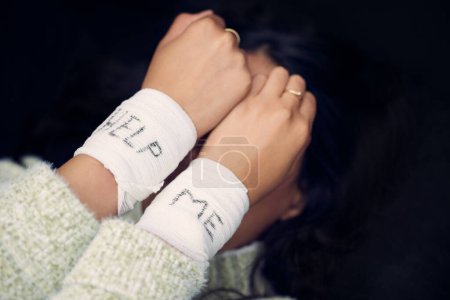Photo for Woman, depression and wrist with help on bandage for suicide, self harm or person in dark mental health crisis. Bandages, girl and injury from depressed accident, problem or mistake in cutting wrists. - Royalty Free Image