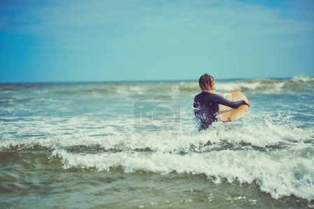 Photo for At one with the water. a beautiful young woman going for a surf at the beach - Royalty Free Image