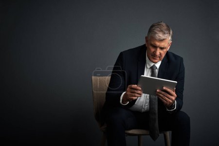 Photo for You create your own road map to success. Studio shot of a mature businessman using his digital tablet - Royalty Free Image
