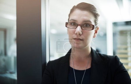 Foto de El trabajo se hace detrás de esta puerta. Retrato de una joven empresaria de pie en la puerta de una oficina - Imagen libre de derechos