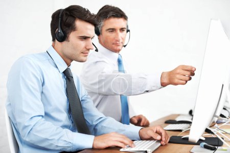 Photo for You need to work on that section...Male customer service agents at work while wearing headsets - Royalty Free Image
