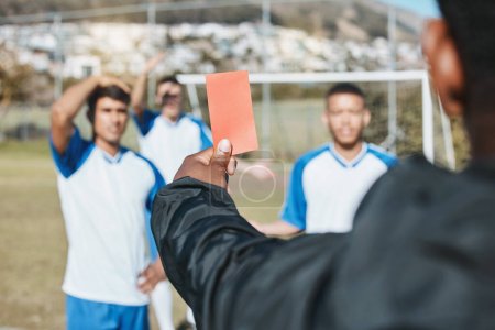 Photo for Sports team, red card and soccer referee outdoor on field for game foul, mistake or compliance. Football player, athlete club and paper in person hand for sport warning, penalty rules or dismissal. - Royalty Free Image