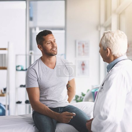 Photo for How an I doing, doc. a senior doctor giving his male patient a thorough checkup during his consultation - Royalty Free Image