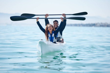 Photo for Kayak, sports and team celebrate win on rowing boat on a lake, ocean or river for fitness challenge. Man and woman or winning couple with a paddle for adventure, teamwork exercise or travel on water. - Royalty Free Image