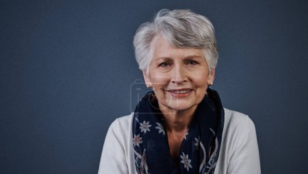 Photo for Life really starts when youre older. Studio shot of a cheerful elderly woman sitting down and looking straight into the camera while smiling - Royalty Free Image