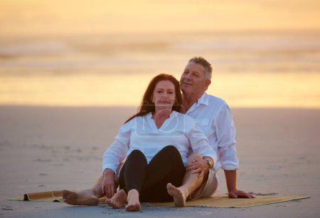 Photo for Never stop the romance. a mature couple relaxing together on the beach - Royalty Free Image