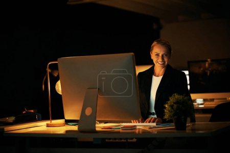 Photo for I dont mind putting in extra hours to satisfy clients. a mature businesswoman working late at the office - Royalty Free Image