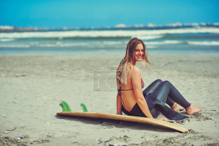 Photo for Its hard not to be happy when youre surfing. a beautiful young woman going for a surf at the beach - Royalty Free Image