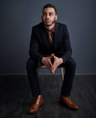 Photo for His brain is working overtime. Studio shot of a stylish young businessman looking thoughtful against a gray background - Royalty Free Image