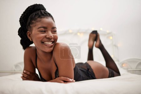 Photo for Happy, sexy and a black woman in lingerie on a bed, thinking and ready for the night. Smile, ideas and an African girl in the bedroom in seductive underwear for confidence, happiness or sensuality. - Royalty Free Image