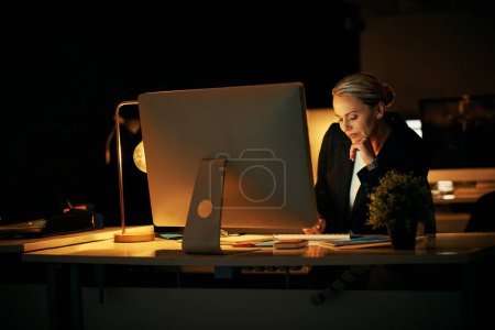 Photo for Im more productive at night. a mature businesswoman working late at the office - Royalty Free Image