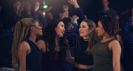 Photo for Music, party and night with women in club for dance, celebration and nightlife concert. Festival, disco and happy hour with friends dancing in crowd at social event for energy, techno and dj show. - Royalty Free Image
