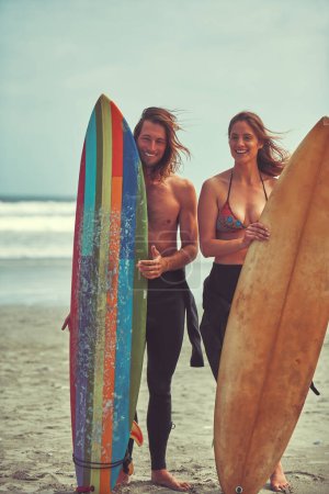 Photo for Just add water. a young couple spending the day out surfing - Royalty Free Image