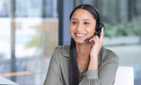 Photo for Woman with smile, callcenter with CRM and contact us, communication with headset and phone call in office. Female consultant in customer service, telemarketing or tech support with help desk job. - Royalty Free Image