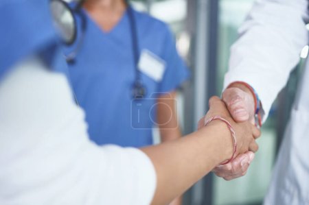 Photo for I wont let you down. an unrecognizable nurse standing and shaking a doctors hand in the clinic - Royalty Free Image