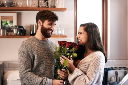 Photo for Flowers, surprise gift and happy couple with roses, floral present or flower bouquet for Valentines Day in home kitchen. Wow, bonding and romantic man with love present, care and enjoy quality time. - Royalty Free Image