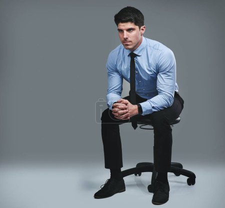 Photo for Its make or break time. Studio shot of a young businessman looking thoughtful against a grey background - Royalty Free Image