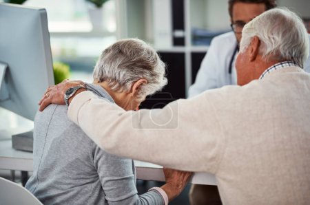 Photo for She just cant deal with all the complications. a senior man consoling his wife during a consultation with a doctor in a clinic - Royalty Free Image