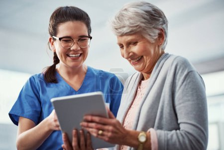Photo for This is wonderful. a young female nurse and her senior patient looking at a tablet in the old age home - Royalty Free Image