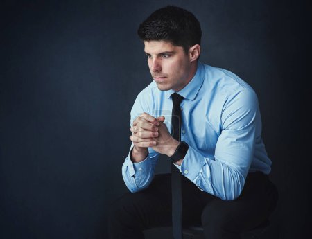 Photo for If you cant make a mistake, you cant make anything. Studio shot of a young businessman looking thoughtful against a dark background - Royalty Free Image