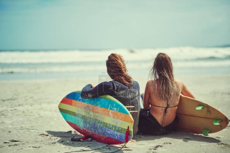 Photo for Surfing soulmates. a young couple surfing at the beach - Royalty Free Image