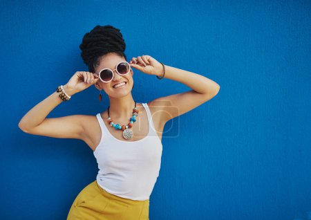 Photo for Fashion, sunglasses and portrait of woman on blue background, wall and summer streetwear, trendy clothes or shades mockup. Girl, happy and excited model with cool style, vision and urban mock up. - Royalty Free Image