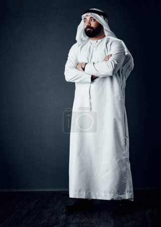 Photo for Determined to make it happen. Studio shot of a young man dressed in Islamic traditional clothing posing against a dark background - Royalty Free Image