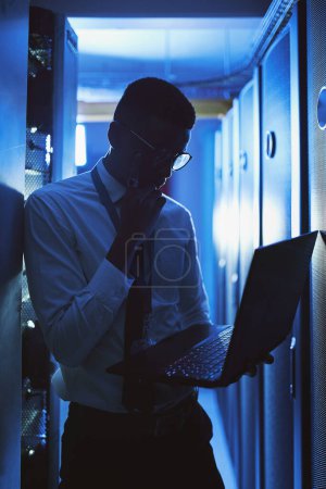 Photo for Im a problem solver. a young man working in an IT server room - Royalty Free Image