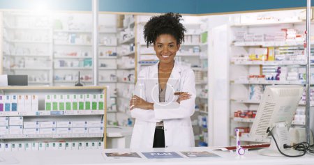 Photo for Im here for all the advice you need. Portrait of an attractive young pharmacist standing behind the counter with arms folded in a chemist - Royalty Free Image