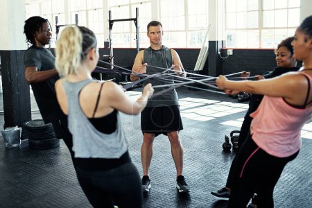 Photo for You can do it with the right support. a fitness group working out with resistance bands in their session at the gym - Royalty Free Image