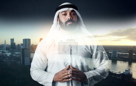Photo for Hes got plans on the way. Studio shot of a young muslim businessman against a cityscape background - Royalty Free Image