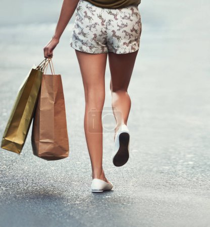 Photo for Shopping bag, street or legs of woman, walking and travel on urban city road after Black Friday discount. Retail, boutique fashion gift or back of customer with mall store purchase on concrete ground. - Royalty Free Image