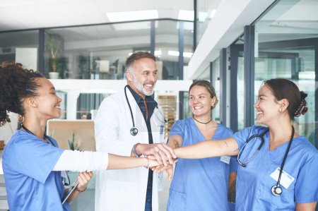 Photo for Heres to curing sometimes, treating often and comforting always. a diverse group of healthcare professionals standing huddled together with their hands piled in the middle - Royalty Free Image