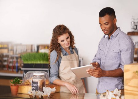 Tablet, coffee shop owner and teamwork of people, discussion and training. Waiters, black man and happy woman in restaurant with technology for inventory, stock check or managing sales in store