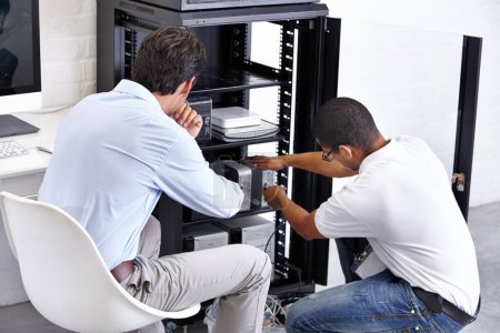 Photo for Server room, man and technician working with electronics for hardware maintenance of glitch in office. IT support, worker and electrical engineer fixing internet connection for information technology. - Royalty Free Image