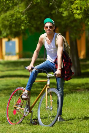 Photo for Bicycle, park and portrait of young man for travel, journey and carbon footprint, streetwear and cool fashion at university. Person or college student in sunglasses, bike transport and outdoor campus. - Royalty Free Image