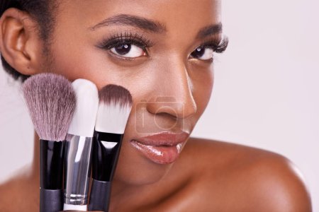 Photo for Skincare, makeup brushes and portrait of black woman with brush on face in studio with cosmetic application tool. Skin care, blush and cosmetics, beauty model with luxury powder on pink background - Royalty Free Image