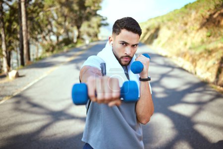 Photo for Man, dumbbell and punch in nature fitness for exercise, workout or training in the outdoors. Portrait of fit, active and sporty male person punching with weights in healthy outdoor cardio endurance. - Royalty Free Image