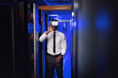 Photo for Experience the future of connectivity. a young man wearing a VR headset while working in a server room - Royalty Free Image