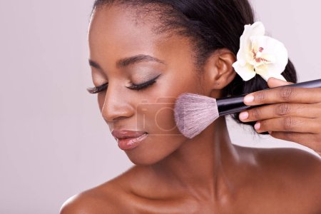 Photo for Cosmetic glow, makeup brush on face and black woman with skincare in studio, cosmetics tool. Skin care, blush and foundation, African beauty model with luxury contour highlight on pink background. - Royalty Free Image
