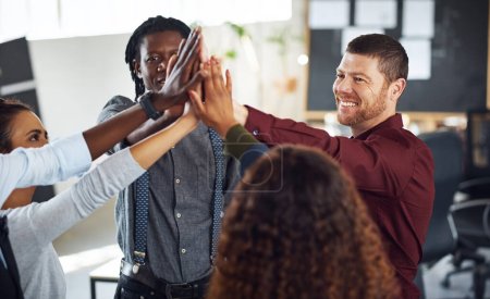 Photo for Winning is what we do. a group of businesspeople high fiving together in an office - Royalty Free Image
