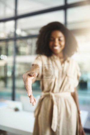 Photo for Lets form a merger. Portrait of a young businesswoman extending a handshake in an office - Royalty Free Image