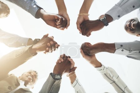 Photo for Youll be rewarded if you help others rise. Closeup shot of a group of businesspeople holding hands - Royalty Free Image