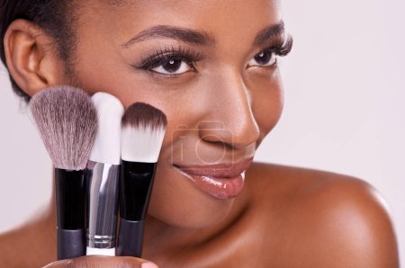 Photo for Cosmetic brushes, makeup and black woman with smile on face in studio and beauty application tool. Skincare, blush and cosmetics, facial skin model with luxury contour product on white background. - Royalty Free Image