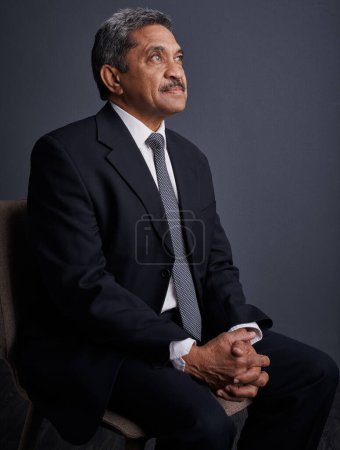 Photo for Understand what you really want in life. Studio shot of a mature businessman posing against a dark background - Royalty Free Image