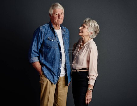 Foto de Sólo bromea. Retrato de estudio de una pareja mayor cariñosa posando sobre un fondo gris - Imagen libre de derechos