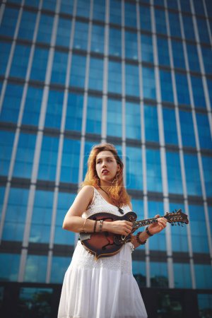 Photo for Im right where Im supposed to be. a beautiful young woman out in the city with her guitar - Royalty Free Image