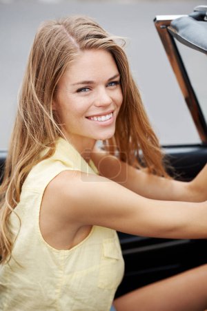 Photo for Taking a drive. A gorgeous young woman relaxing in a convertible while on a roadtrip - Royalty Free Image